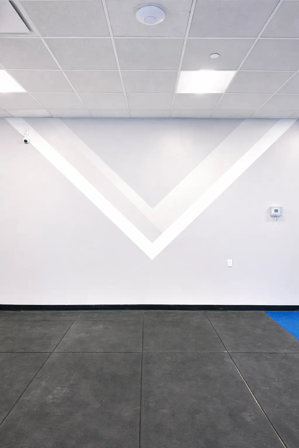 The same office suite after painting: clean even walls, crisp white door frames and trim, one wall finished in a deep accent color.